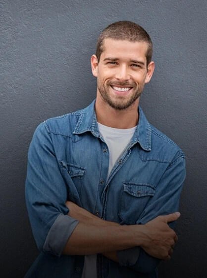 Smiling young man after oral surgery in Waco