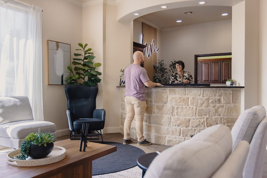 Dental Patient Speaking With Care Coordinator at Waco Dental Office Reception Desk